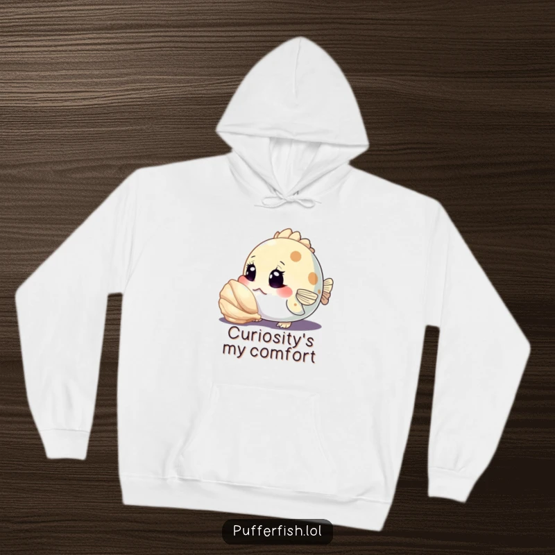 Funny hoodie featuring a curious pufferfish character inspecting a shiny seashell with wide eyes, perfect for cozy, inquisitive wear.