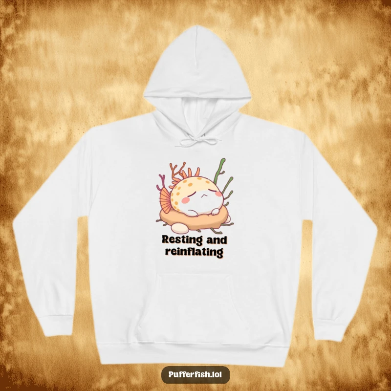 Funny Pufferfish Hoodie: A content pufferfish slumbers peacefully on a lush bed of seaweed, exuding calm humor.