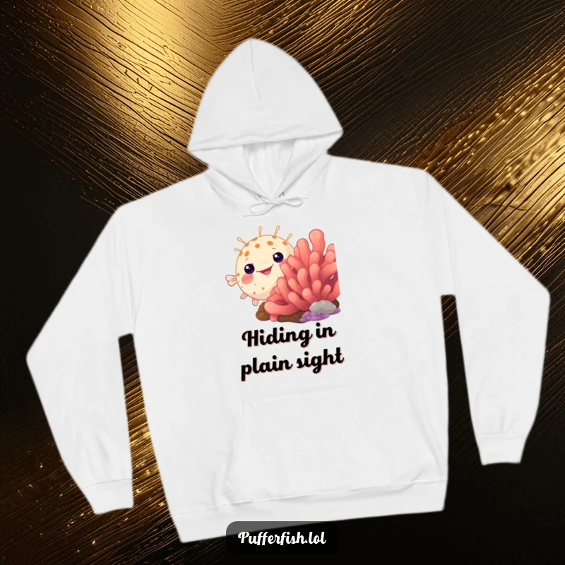 Funny pufferfish hoodie, humorously peeking from behind a vibrant coral, a cozy and amusing design for ocean fans.