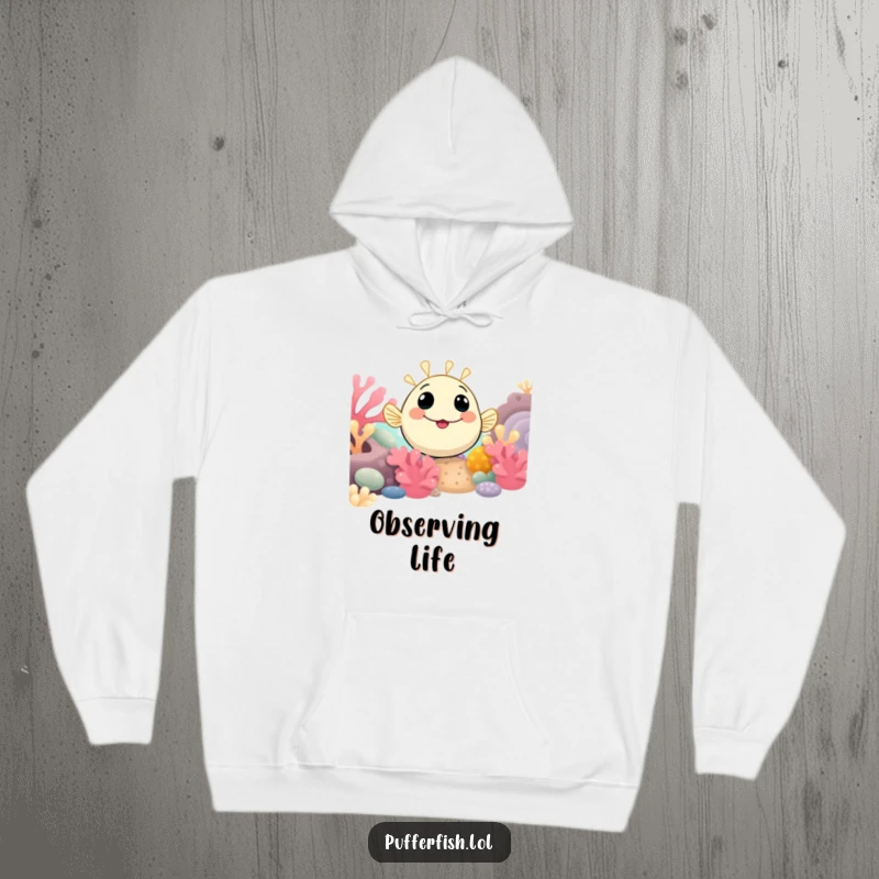 Funny Pufferfish Hoodie showing a smiling pufferfish curiously peeking from a vibrant coral reef, designed for cozy exploration.